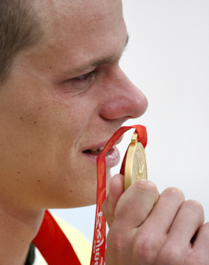 Cesar Cielo holds his gold medal in the men's 50 free at the Beijing Olympics